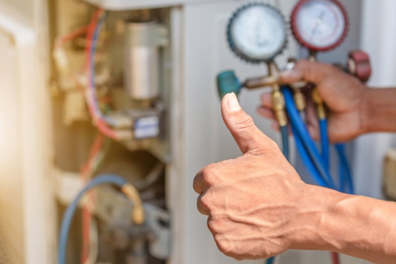 Close up of Air Conditioning Repair, repairman on the floor fixing air conditioning system